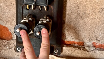 An antique household electricity meter with push-button type electric fuses in the garage. The...