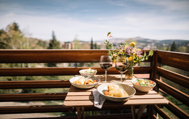 Small balcony idyll with meal and wine