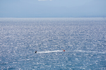 Lone Jet Skier Gliding Across Sparkling Ocean Waters Under a Clear Sky