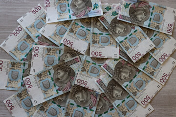 Polish 500 zloty banknotes scattered on the desk