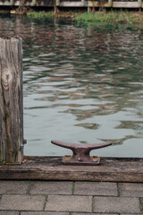 rusty cleat on dock by lake