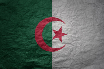 big national flag of algeria on a grunge old paper texture background
