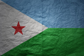 big national flag of djibouti on a grunge old paper texture background