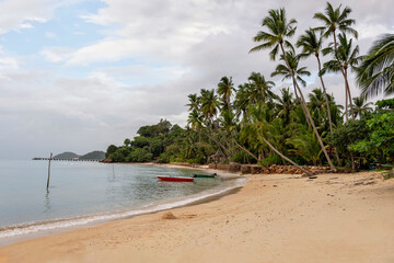 Lonely beach with boat and palm trees, Koh Samui, Thailand