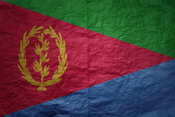 big national flag of eritrea on a grunge old paper texture background