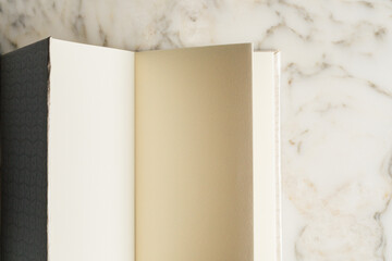 blank pages in handmade book on white marble table
