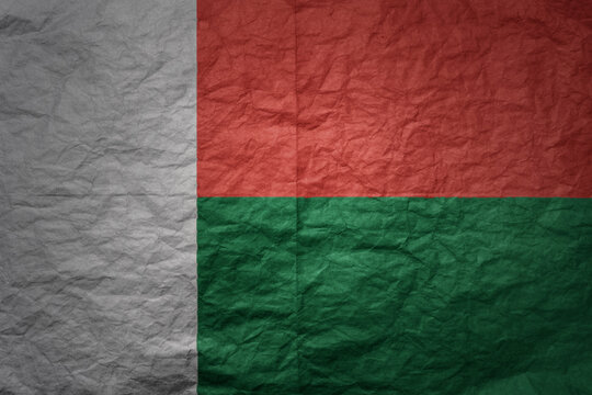big national flag of madagascar on a grunge old paper texture background