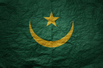 big national flag of mauritania on a grunge old paper texture background