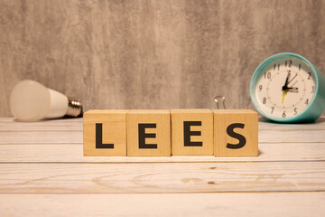 Having less stress or being stress-less. The word LESS on wooden cubes.