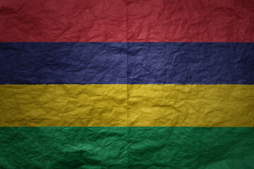 big national flag of mauritius on a grunge old paper texture background