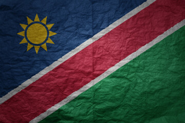 big national flag of namibia on a grunge old paper texture background