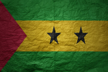 big national flag of sao tome and principe on a grunge old paper texture background