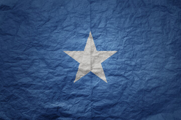 big national flag of somalia on a grunge old paper texture background