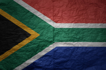 big national flag of south africa on a grunge old paper texture background