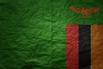 Foto op Aluminium big national flag of zambia on a grunge old paper texture background © luzitanija