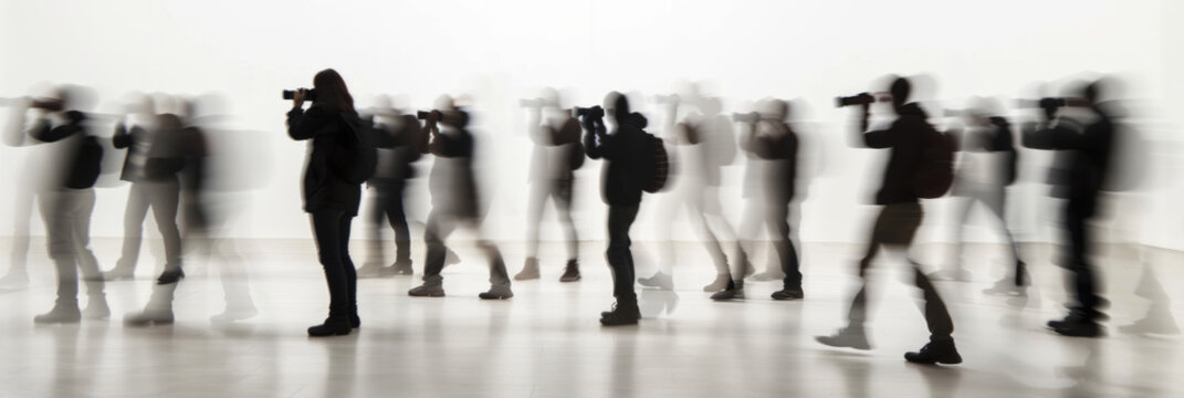 a long exposure photograph of multiple people photographers taking pictures, motion blur