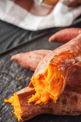 baked sweet potatoes on a dark wooden rustic background