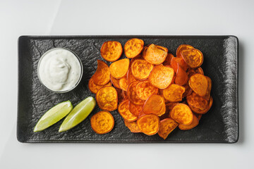 sweet potato chips on white acrylic background