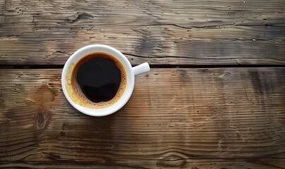 a white cup of coffee on wooden table, in the style of aerial view