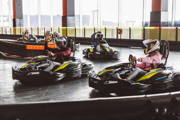 Kart racers take to the track to compete. A competitor hits a car in the race while in the...