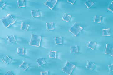 Fototapeta na wymiar Ice cubes pattern on light blue background. Minimal summer drink concept. Trendy summertime pattern backdrop. Flat lay, top of view.