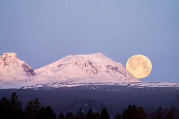 Moonset over a mountain