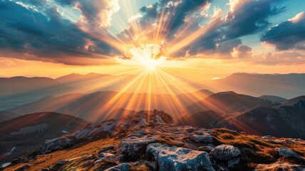 Sunrise over mountainous landscape with sunbeams piercing through clouds - obrazy, fototapety, plakaty