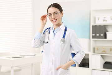 Medical consultant with glasses and stethoscope in clinic