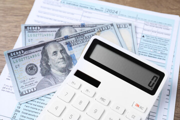 Obraz premium Tax accounting. Calculator, document and dollar banknotes on table, closeup