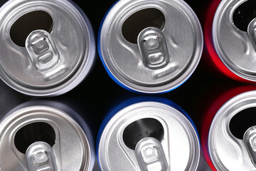 Energy drinks in cans as background, top view. Functional beverage