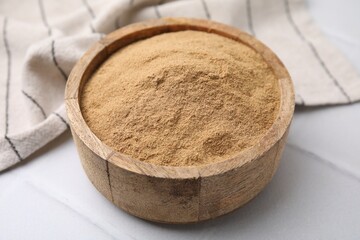 Dietary fiber. Psyllium husk powder in bowl on white table