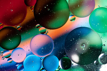 Colorful abstraction of oil bubbles in water. View from above. Macro photography.