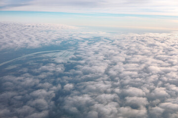 Fototapeta na wymiar Aerial view of clouds over the Earth. Flying through the clouds in the morning 
