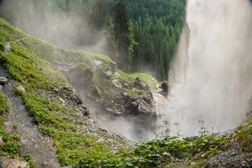  waterfall from a high cliff. water flow down.Streams of water crash on rocks and boulders. stormy stream of water with drops and splashes.Downward movement of water. - 786743554