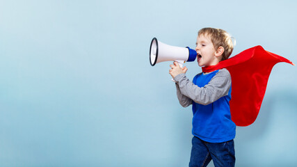 Child in Cape with Megaphone on Blue Background