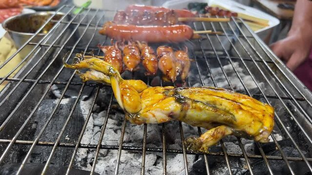 Frogs preparets for grill on food street Bukit Bintang in Kuala Lumpur