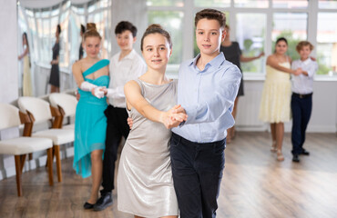 Happy interested teenage students preparing for college festive event, rehearsing ballroom dance...