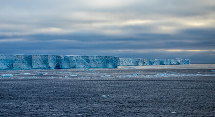 a large tabular iceberg floating off the Antarctic Peninsula into the Scotia Sea