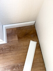 Installing Vinyl Baseboards in a Modern Home Renovation Project - 786757542