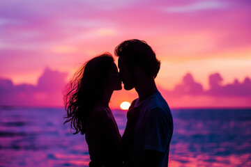 Silhouette of a couple sharing a kiss against a colorful sunset