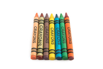 overhead view of a row of colorful crayons with a generic label isolated on white