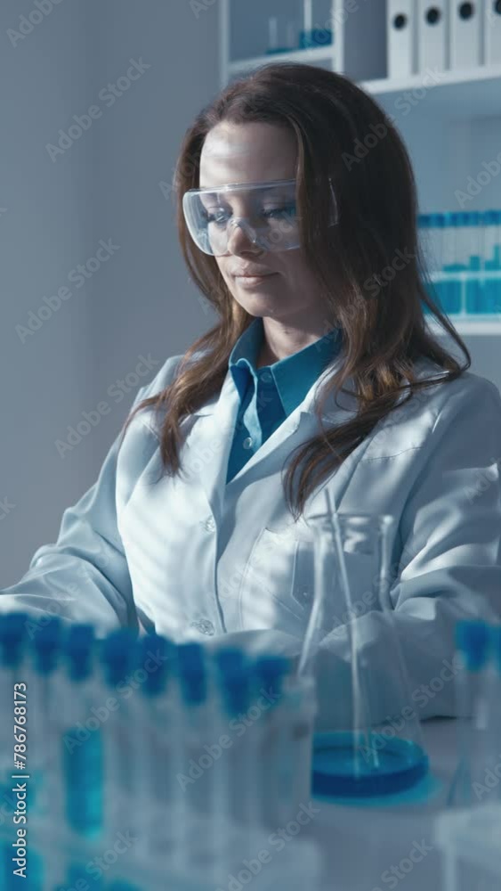 Fototapete A geneticist scientist using a computer and a microscope studies the structure and function of genes in a laboratory using molecular biology techniques. His research is helping to unravel cockroach