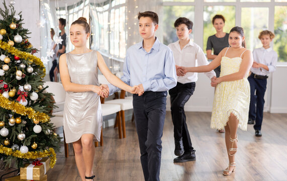 Group of boys and girls dancing traditional folk dance in studio