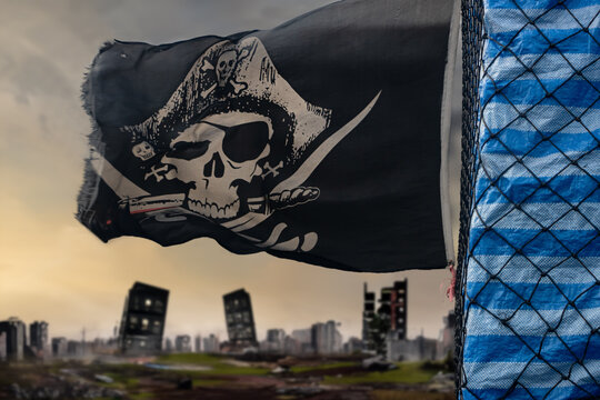 A pirate flag flies behind a moving pickup truck with cargo,  on a background of city ruins