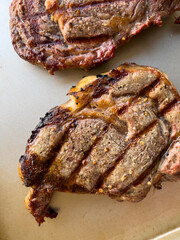 Perfectly Grilled Ribeye Steaks with Charred Edges and Grill Marks