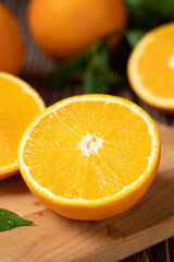 Obraz na płótnie Canvas Fresh orange with cut in half on wooden table.