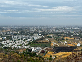 A city with a mountain in the background at Ralamandal, Indore, India.