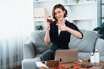 Young happy woman buy product by online shopping at home while ordering items from the internet with credit card online payment system protected by utmost cyber security from online store platform - obrazy, fototapety, plakaty