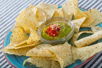 Foto op Plexiglas Close up of corn chips nachos on plate with guacamole sauce © JackF
