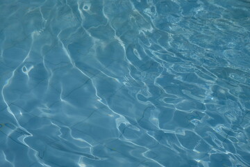 Crystal clear water on the blue swimming pool. This picture is suitable for background or wallpaper.